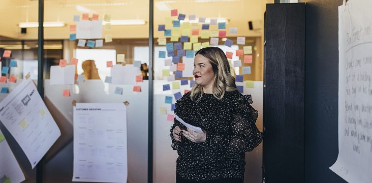 A fair-haired woman in a dark patterned blouse looking to the side – A deep dive into open source