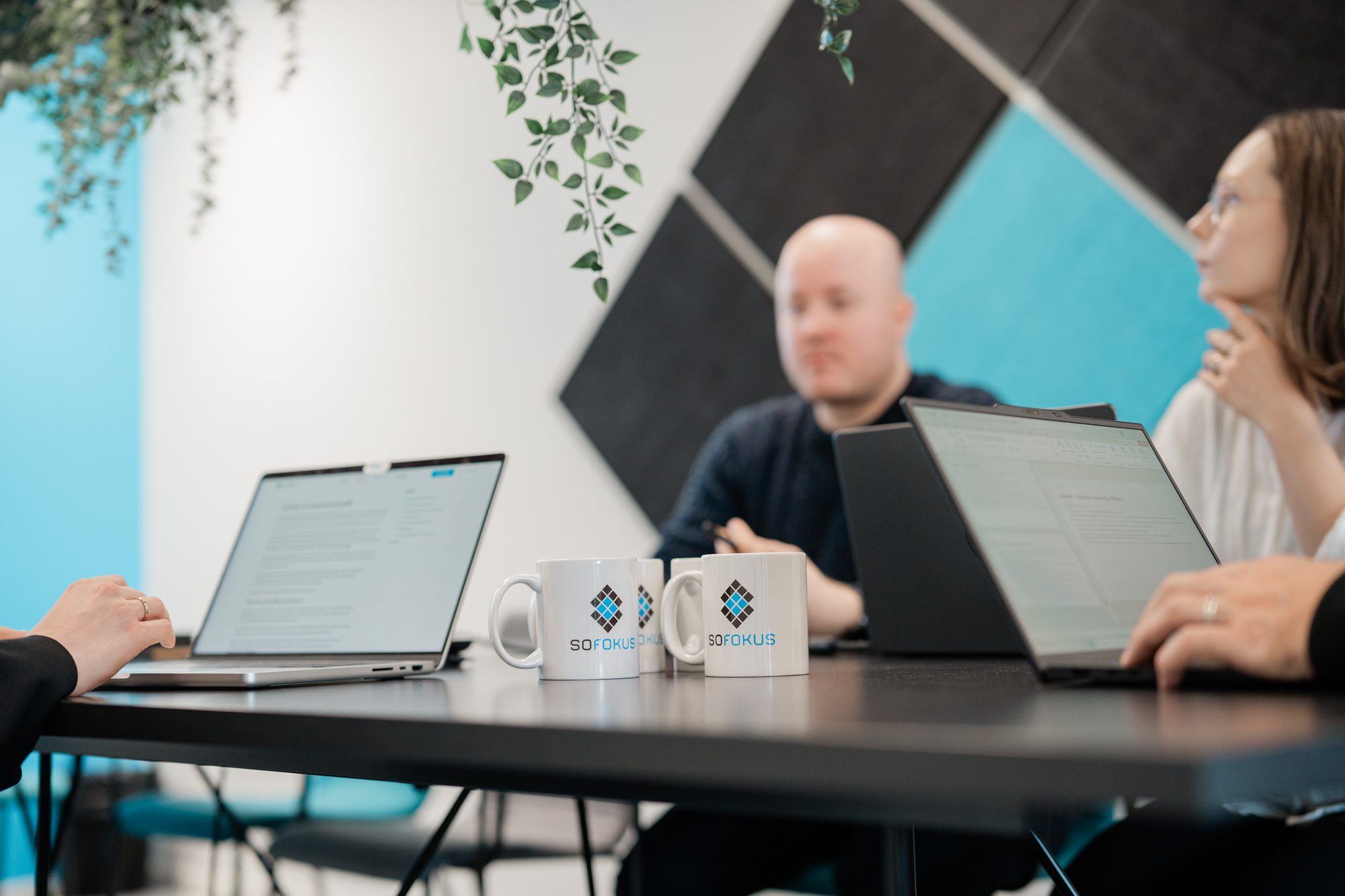 Two Sofokus mugs between laptops on a dark meeting table – Sofokus Ventures launches DHC II