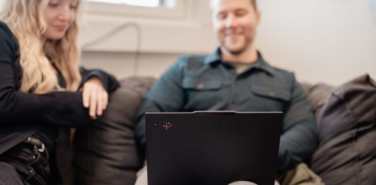 Two people sitting on a dark sofa in a bright room – A deep dive into open source