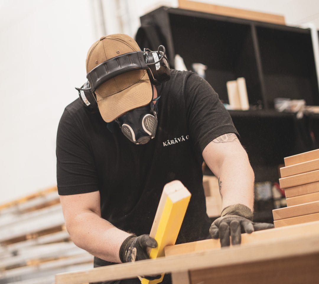 A Kärävä craftsman shaping wood products in the workshop