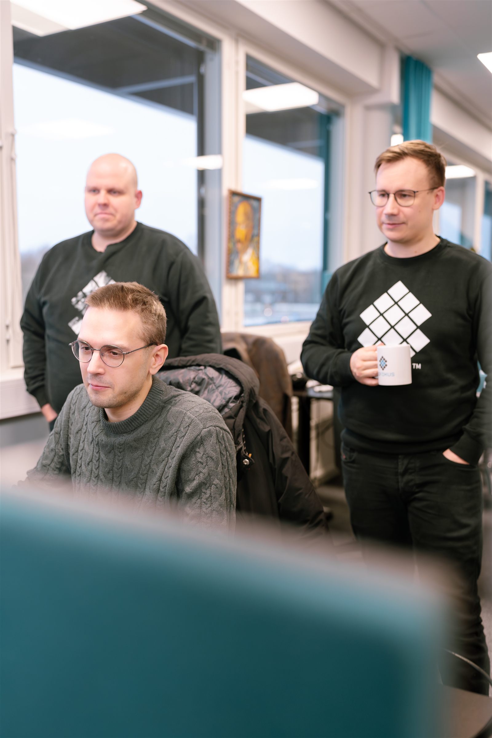 Sofokus developers reviewing work together at the office